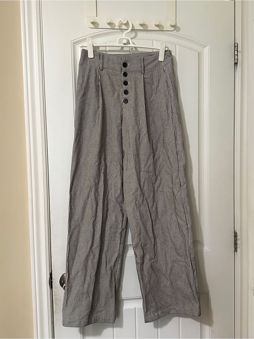 white and black vertical striped pants with button detail